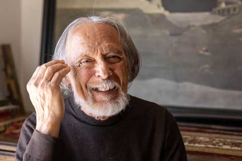 >Window light portrait of Raúl Perez, a prominant Portuguese artist associated with the surrealist movement.